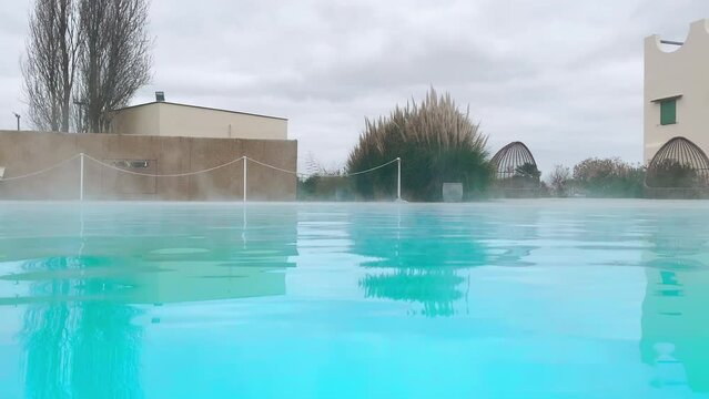 Blue hot water thermal pool with sulfur steaming in tourists resort, geothermal baths with healing benefits and properties for human health, hot water springs stimulating energy and digestive systems
