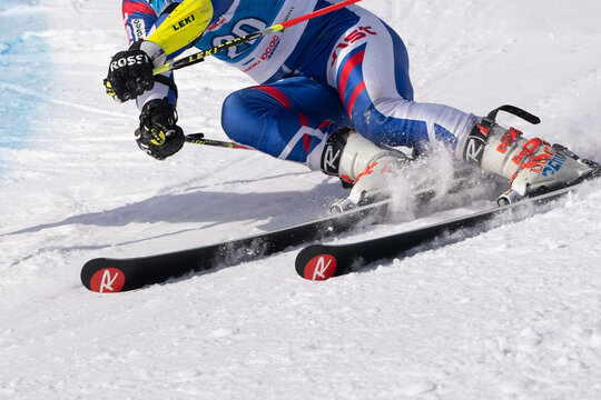 KAMCHATKA, RUSSIA - APR 1, 2019: Crop closeup view of skier sportsperson skiing down an alpine mount ski slope. Russian Alpine Skiing Cup, International Ski Federation FIS Championship, giant slalom