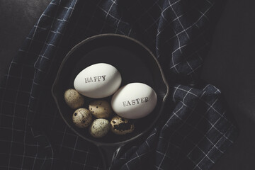 Quail eggs with Happy Easter stamped white eggs in stoneware pan