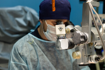 A veterinary surgeon performs surgery on a pet's eyes in a veterinary clinic. An ophthalmologist...