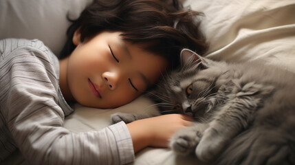Small Asian child lies on a bed with a cat. Kitten and baby childhood friendship. Baby and cat. Child and Kitten lying together on the bed