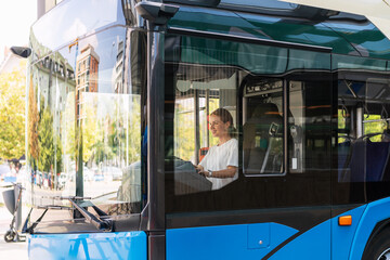 Woman bus driver, female's occupation in city.
