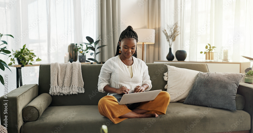 Canvas Prints Black woman on sofa, smile and typing on laptop for remote work, social media or blog post research in home. Happy girl on couch with computer checking email, website or online chat in living room.