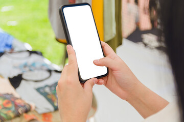 Caucasian female hands of unrecognizable woman holding phone at craft fair. copy space.