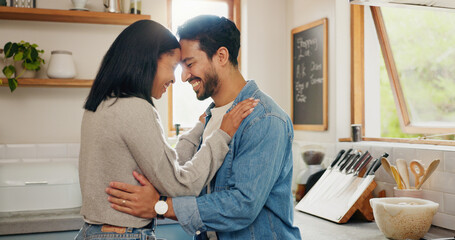 Love, hug and couple in a kitchen happy, together and intimate while bonding in their home....