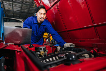 Portrait Asian Japanese male mechanic worker portrait in auto service workshop car maintenance...