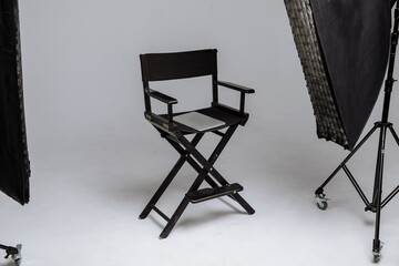 Director's chair in photo studio with laptop and flashes