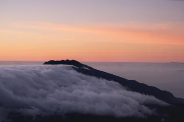 Foto op Canvas Sunrise in mountains with inversion phenomenon and low clouds lit by sun. Refugio Punta de Los Roques, National Park Caldera de Taburiente, La Palma, Canary Islands, Spain © Iwona