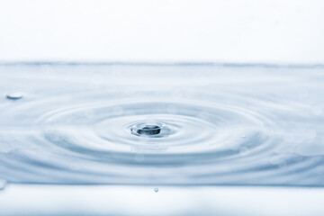 Close-up of a water droplet splashing, creating mesmerizing ripples.