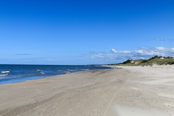 Fototapeta na wymiar The coast of the Baltic Sea near Leba destination and Slovenian National Park with the largest sand dunes in Europe