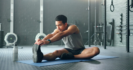 Man, break and stretching on gym floor in fitness, workout or training for strong muscles, heart...