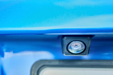 Luxury blue car rear view camera for parking assistance selective focus closeup with copy space. Concept of safety car driving while parking process. Assist device equipment in modern cars.