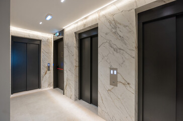 Passenger elevator doors in corridor with marble walls © rilueda