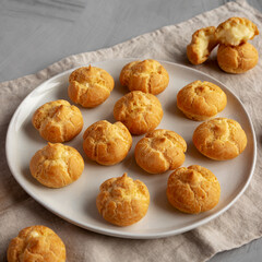 Homemade Mini Cream Puffs on a Plate, side view.