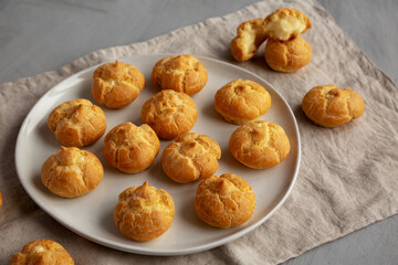 Homemade Mini Cream Puffs on a Plate, side view.