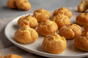 Homemade Mini Cream Puffs on a Plate, low angle view. Close-up.