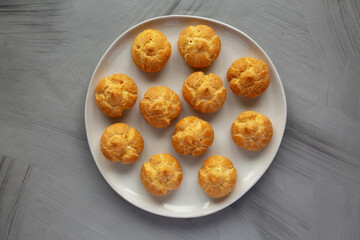 Homemade Mini Cream Puffs on a Plate, top view. Flat lay, overhead, from above.