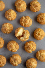 Homemade Mini Cream Puffs on a gray background, top view. Flat lay, overhead, from above.