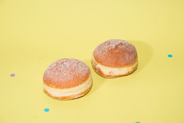 Traditional German Carnival Sweets  Berliner, Pfannkuchen or Krapfen in front of a colourful background