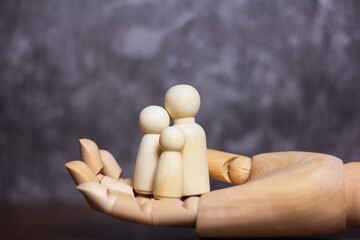 Family wooden puppets on tabel Life insurance ideas for future financial security and protection...