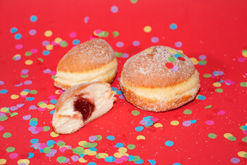 Traditional German Carnival Sweets  Berliner, Pfannkuchen or Krapfen in front of a colourful background