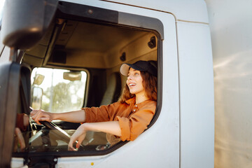 Female driver looking out of truck window. Transport industry theme