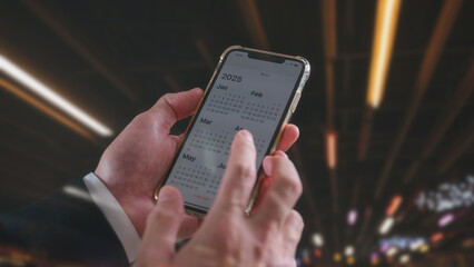 Time management financial planning and reminder for 2025. businessman using smartphone working with...