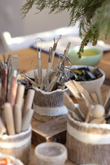 Cutters, profiles, stacks, molds for pottery in unusual ceramic mug on the table