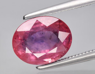 natural pink sapphire gem on the background