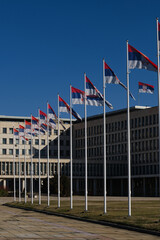 Palace of Serbia, Novi Beograd district. A lot of Flags of Serbia waiving in front of Palata Srbija. Office of various state administrations in Belgrade. - obrazy, fototapety, plakaty