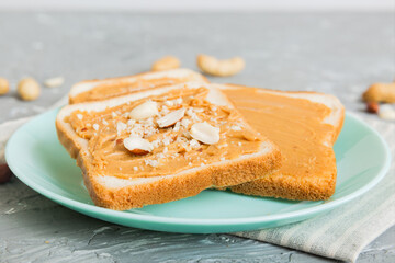 Peanut butter sandwiches or toasts on light table background.Breakfast. Vegetarian food. American cuisine top view vith copy space