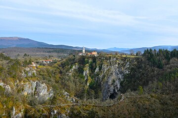 View of the church at Skocjan village and Velika dolina bellow in Škocjan caves in Primorska, Slovenia