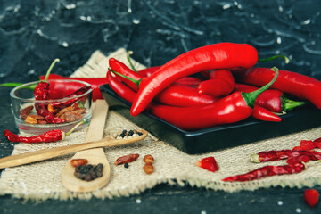 Red hot chili pepper composition, spicy organic paprika and different seasonings background