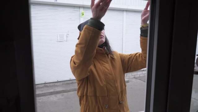 Female Business Owner of Local Store opening garage storefront