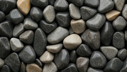 Gabbro rock texture showcasing a pattern of smooth, polished pebbles in various shades of gray and subtle whites.