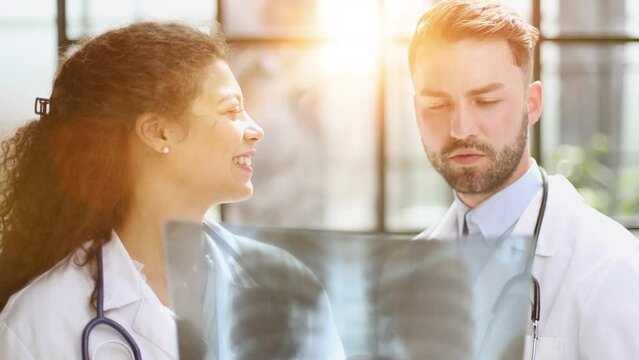 male doctor and female doctors with x-ray results. Professional consulting.
