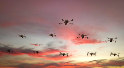 Group of surveillance drones in front  with sunset sky scene background