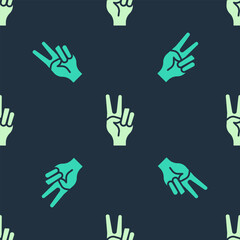 Green and beige Hand showing two finger icon isolated seamless pattern on blue background. Hand gesture V sign for victory or peace. Vector