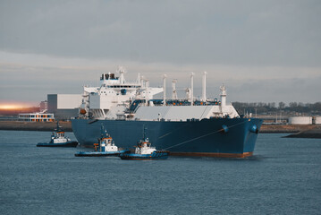 LNG Tanker Mooring In The International Trade Port. Gas Transportation Facility. Natural Gas...