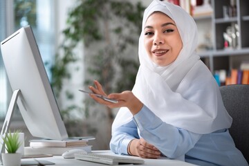 Busy arabian businesswoman wear hijab work on computer