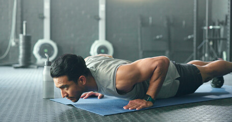 Fitness, man and pushups for muscle, exercise or training workout for strength or power at the gym....