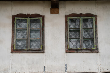 Croatia, October 20,2023 : Rustic style aged window at rural home wall.