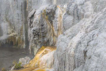 Fototapeta na wymiar gray and yellow stone texture at rotorua geyser in new zealand