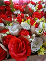 Red rose and group of colorful roses in flower shop