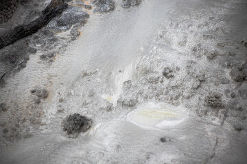 gray stone texture in rotorua geyser in new zealand with water