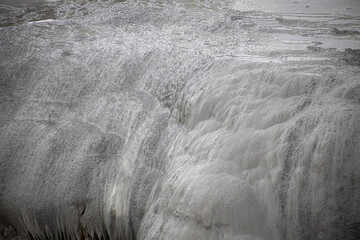 gray stone texture in rotorua geyser in new zealand with water