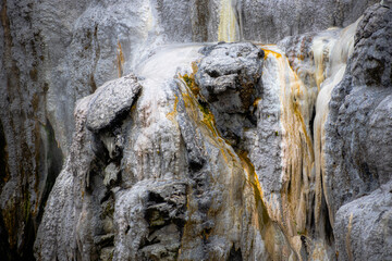 gray and yellow stone texture at rotorua geyser in new zealand