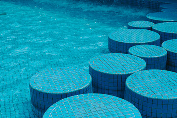 Blue round steps along the large swimming pool