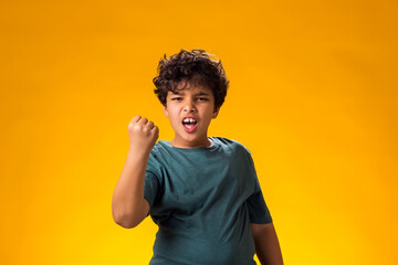 Angry child boy showing fist at camera. Negative emotions concept