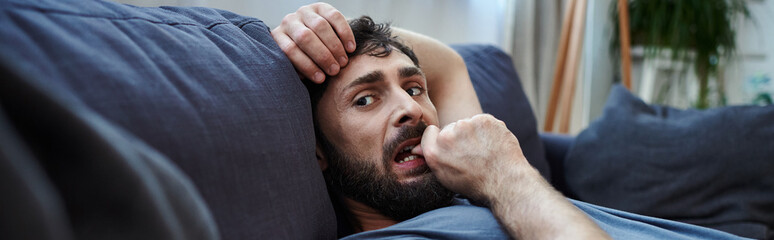 depressed hopeless man in home wear lying on sofa during mental breakdown, psychotherapy, banner - 730107733